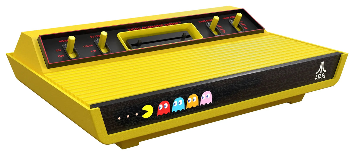 Żółta konsola Atari z motywem Pac-Mana, idealna dla retro gamingu i kolekcjonerskich setupów